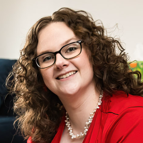 Headshot of Sarah McNaughton, Founder and CEO of McNaughton Digital Media, in a bright red shirt